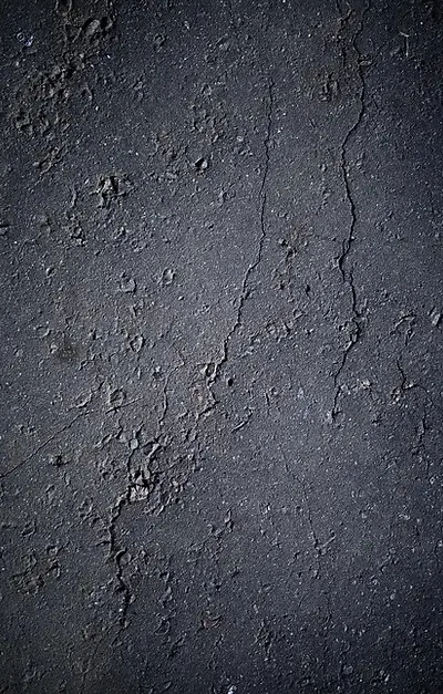 Cracked asphalt surface showing poor sealing results